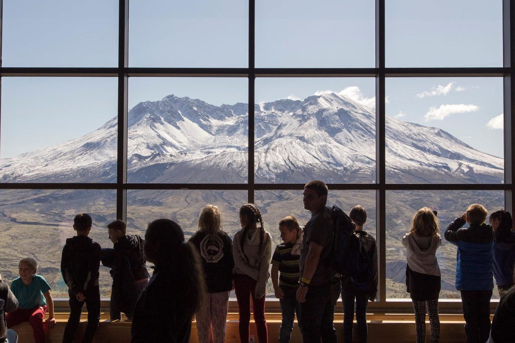 Students look out the window at Mt. St. Helens from the Johnston Ridge Observatory.